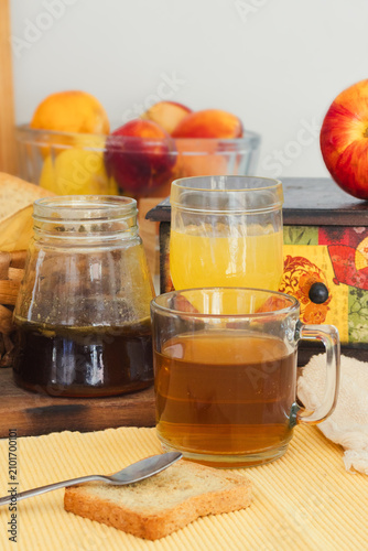 Bild auf Leinwand Healthy breakfast featuring honey, tea, juice, fruit, and rusks, representing or