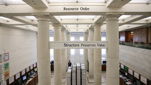 Modern Office Interior with Columns, Resource Management Displays, and Structured Work Environment in a Corporate Setting