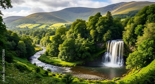 Lush Green Waterfall Flowing Through Scenic Forest Valley