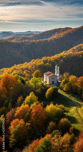 Small White Church Nestled in Colorful Autumn Forest on Mountain Hillside