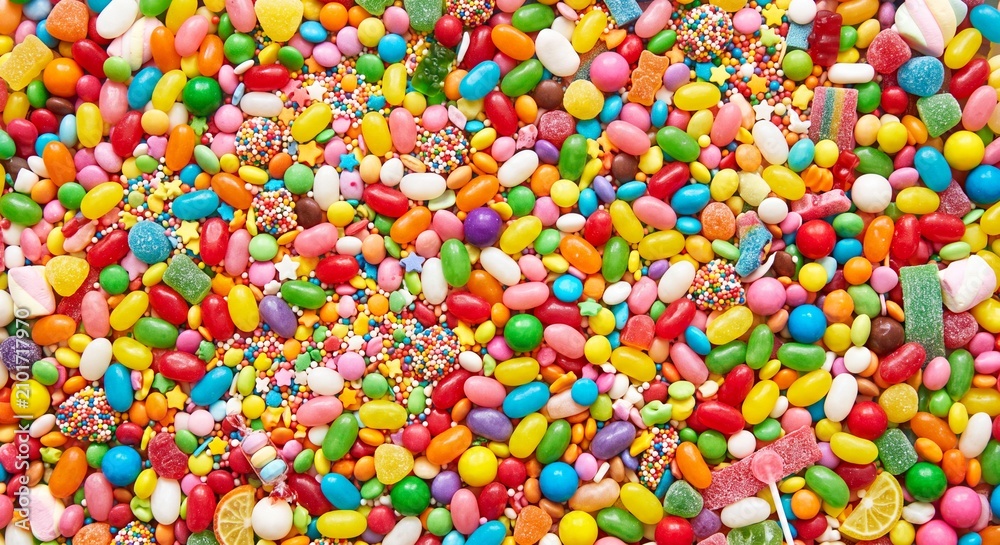 Fototapeta premium A full frame dense texture background of countless multi colored small candy sprinkles and sweet confections