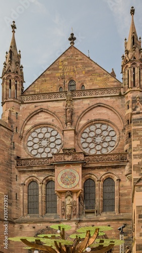 The majestic facade of Strasbourg Cathedral features unique historic clocks.