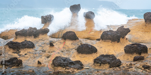 Fotografie Scenic view of hoodoo stones rock formation with wave crashing on rocks in Yehli