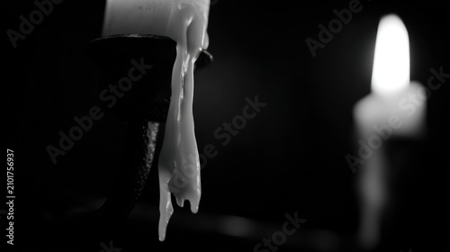 Close up of a melting candle with light and dark background