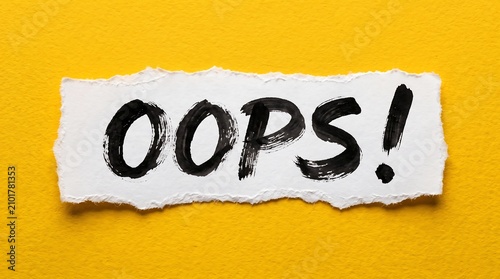 A torn white paper scrap with the word 