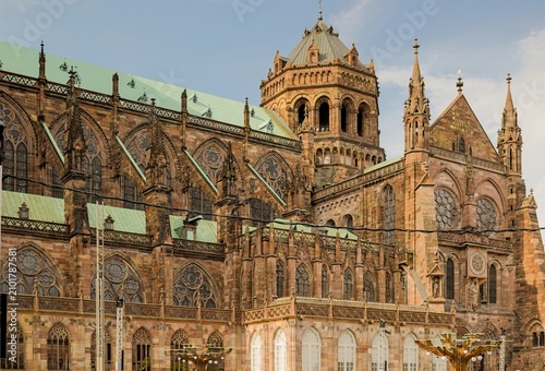 The majestic side facade of Strasbourg Cathedral in France exhibits historic architecture.