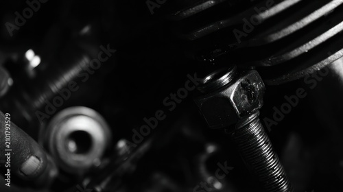 Close up black and white image of mechanical parts and components