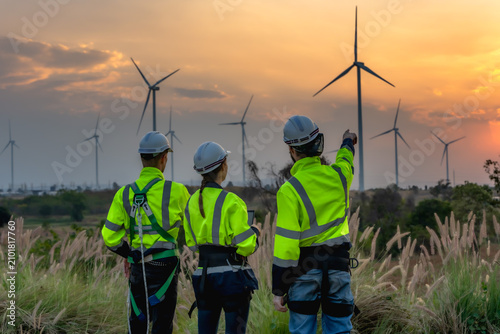 Quadro su tela Rear view team of technicians working until dusk, conducting maintenance checks