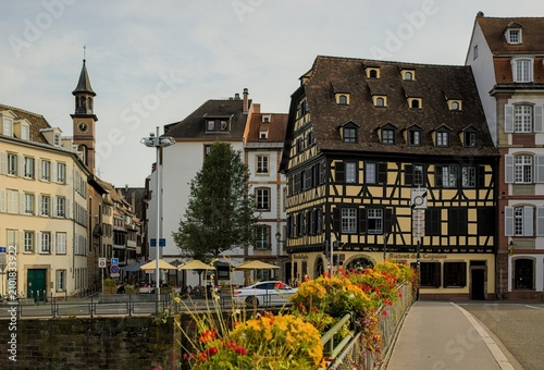 A scenic street view showcases traditional timber framed buildings in Strasbourg, France.