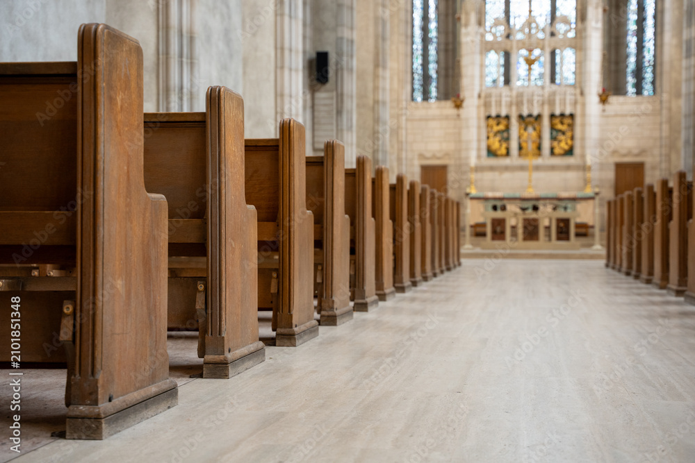 Fototapeta premium Close up view of wooden church pews and aisle.