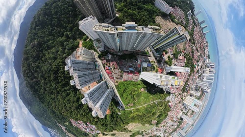 Aerial perspective of tall apartment buildings surrounded by lush green landscape, showcasing urban development