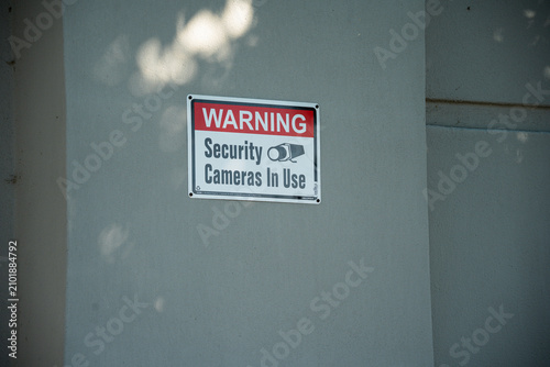 Принти на полотні Warning security cameras in use sign mounted on a textured wall
