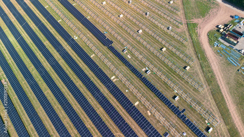 Fotografie Aerial top down view of solar farm under construction with photovoltaic panel ro