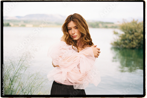 Woman posing in ruffled pink tulle blouse 