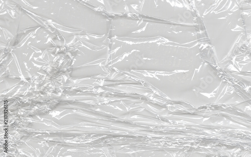 фотографія Scratched clear membrane gathers irregular glossy wrinkles around a folded plane