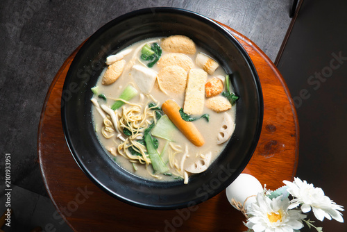 Photography Hot Pot Meal: A steaming bowl of hot pot brimming with a variety of fresh ingredients like vegetables, noodles, and meatballs, ready to be enjoyed