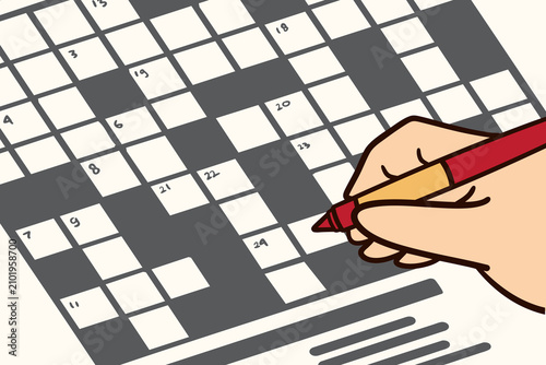 Hand Filling Out Crossword Puzzle