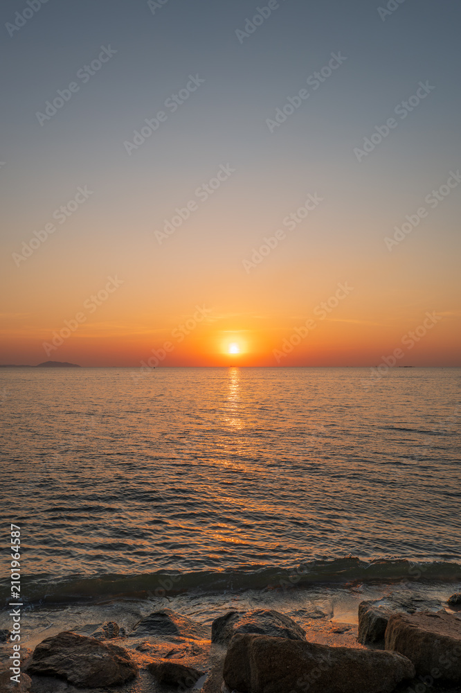 Fototapeta premium Orange Sunset Over Calm Ocean Background Blur
