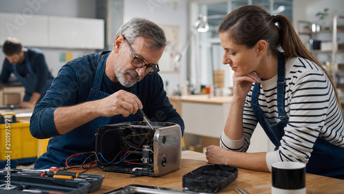 Volunteers Repair a Small Appliance at a Community Workshop