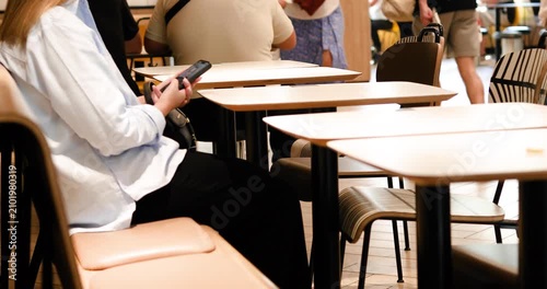waiting for an order on the phone at a table in a restaurant.