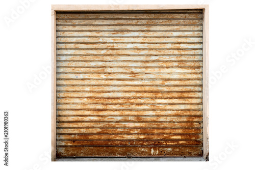 Old weathered and rusted metal roller shutter door of a garage or shop. Grunge industrial background texture with heavy rust corrosion on iron surface. Isolated on white with clipping path