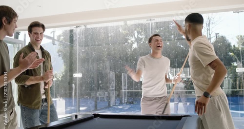 Diverse men breaking rack, player striking cue ball at black-felt pool table at home playing pool