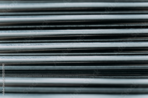 Fotografía Closeup of horizontal steel metallic rods stacked together, showing industrial lines, textures, and shiny silver reflections for construction backgrounds