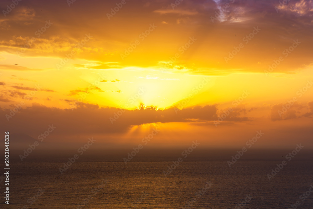 Fototapeta premium beautiful sunrise or sunset seascape with amazing calm sea water with waves and colorful amazing cloudy morning sky on background