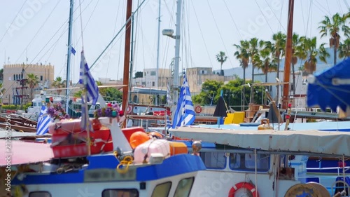 A Greek flag on a moored ship in the harbor in slow motion 60fps