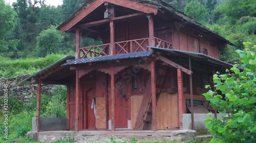 Rustic wooden cabin in green forest landscape