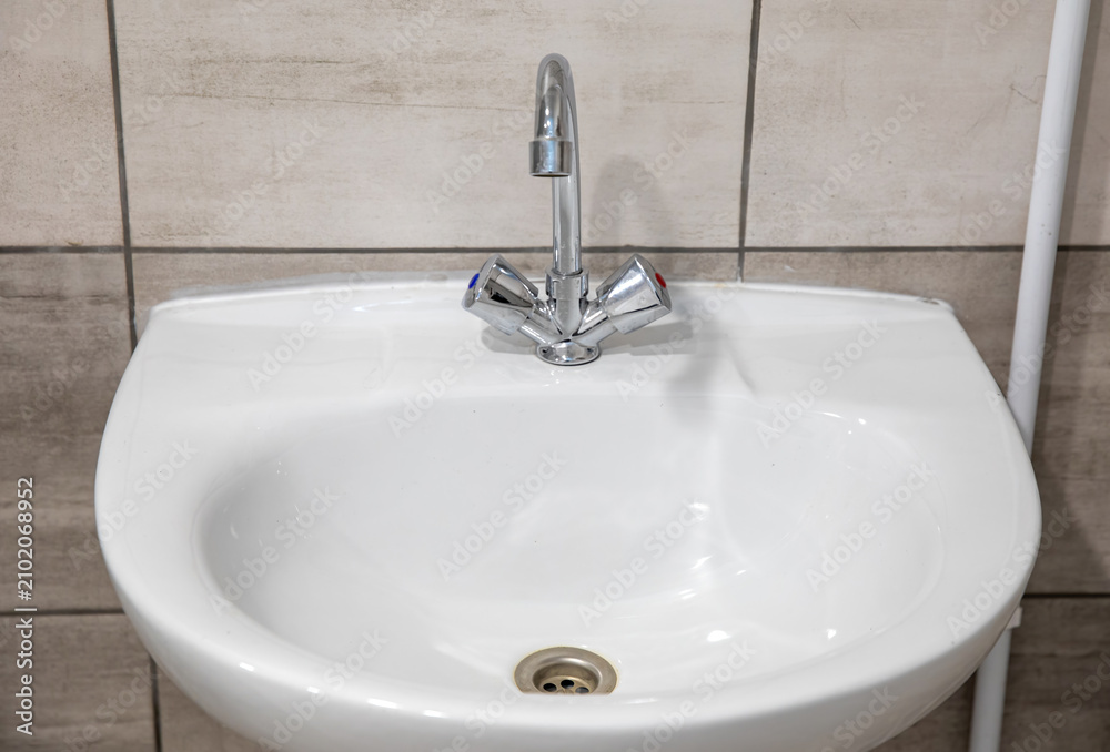 Fototapeta premium White washbasin with a chrome faucet.