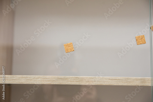 Anti-impact cork pads for cabinet door glass.