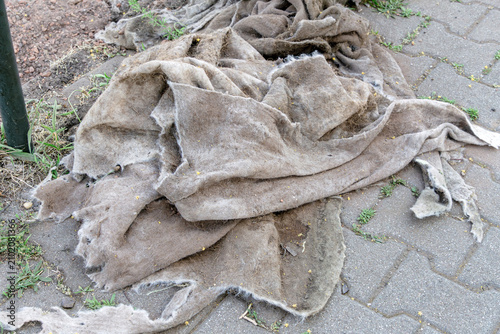 Weathered geotextile material fabric lies on the ground at a tram track construction site