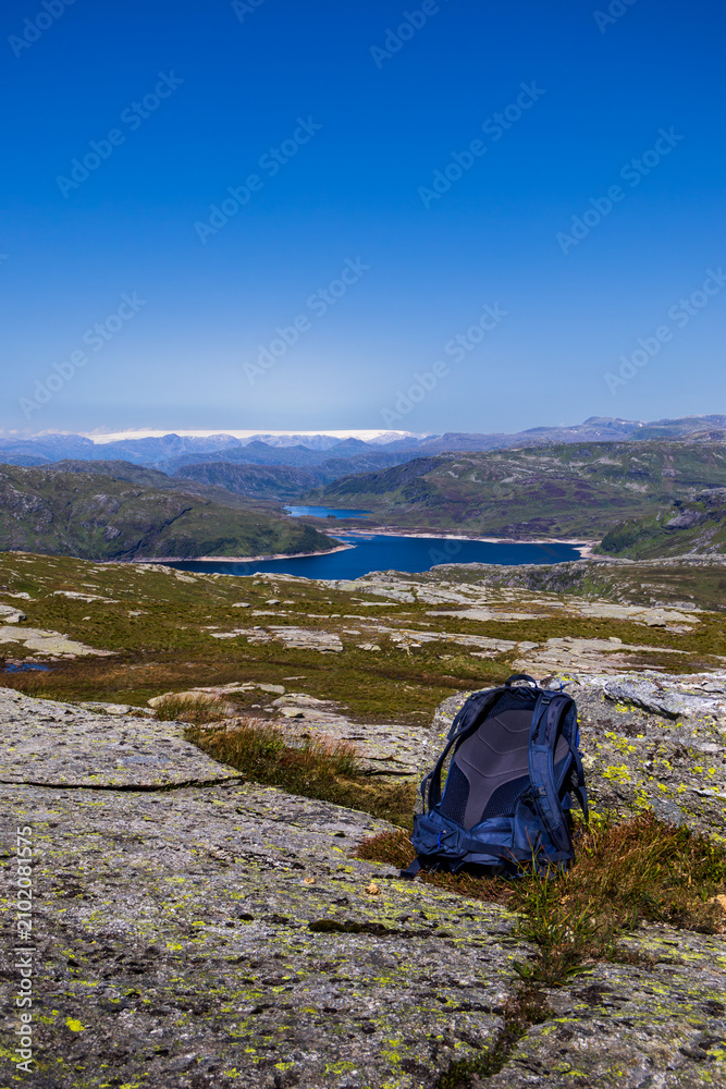 Fototapeta premium Backpack Overlooking Folgefonna and Mountain Lakes from Grindheimsnuten, Etne, Norway