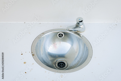 фотографія One small round undermount sink with chrome faucet.
