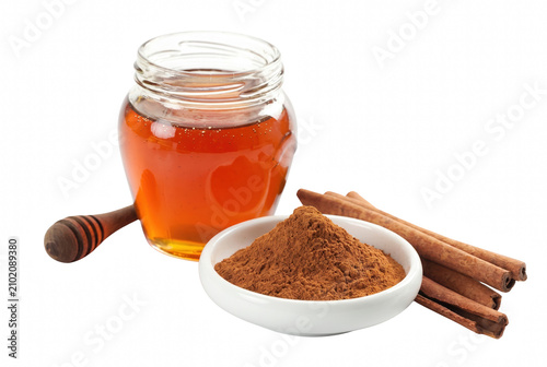 Fotografía Natural Honey in Glass Jar with Aromatic Cinnamon Powder and Sticks