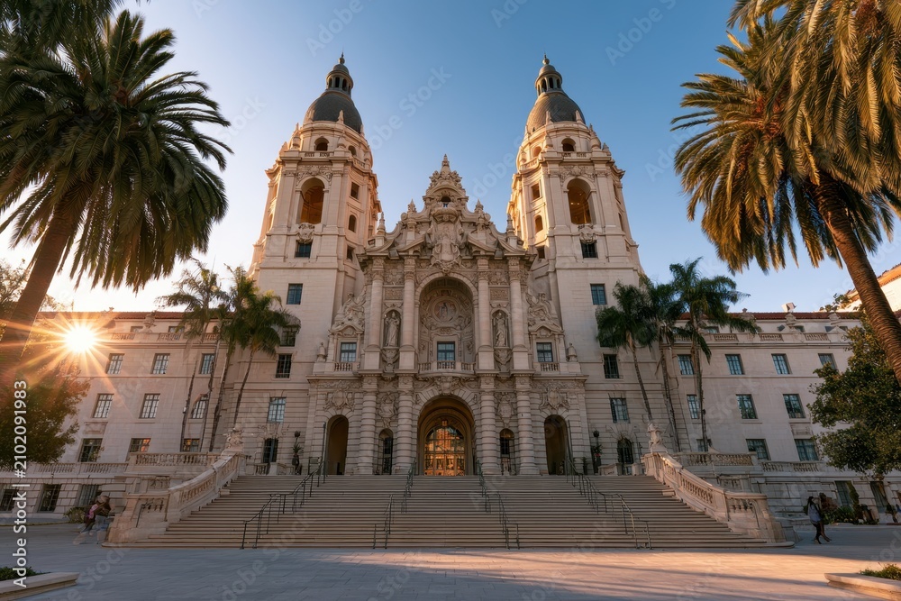 Fototapeta premium Historic California city hall building with grand staircase and ornate stonework at sunset
