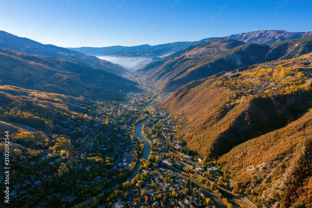 Fototapeta premium Drone view of fall colors shaping Glenwood Springs countryside and mountains