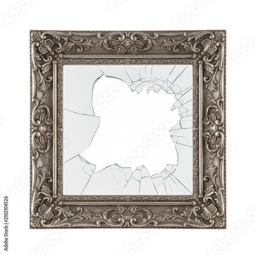 Ornate antique silver frame with intricate filigree and delicate engravings, shattered glass shards clinging to edges, empty center, concept of irreparable damage