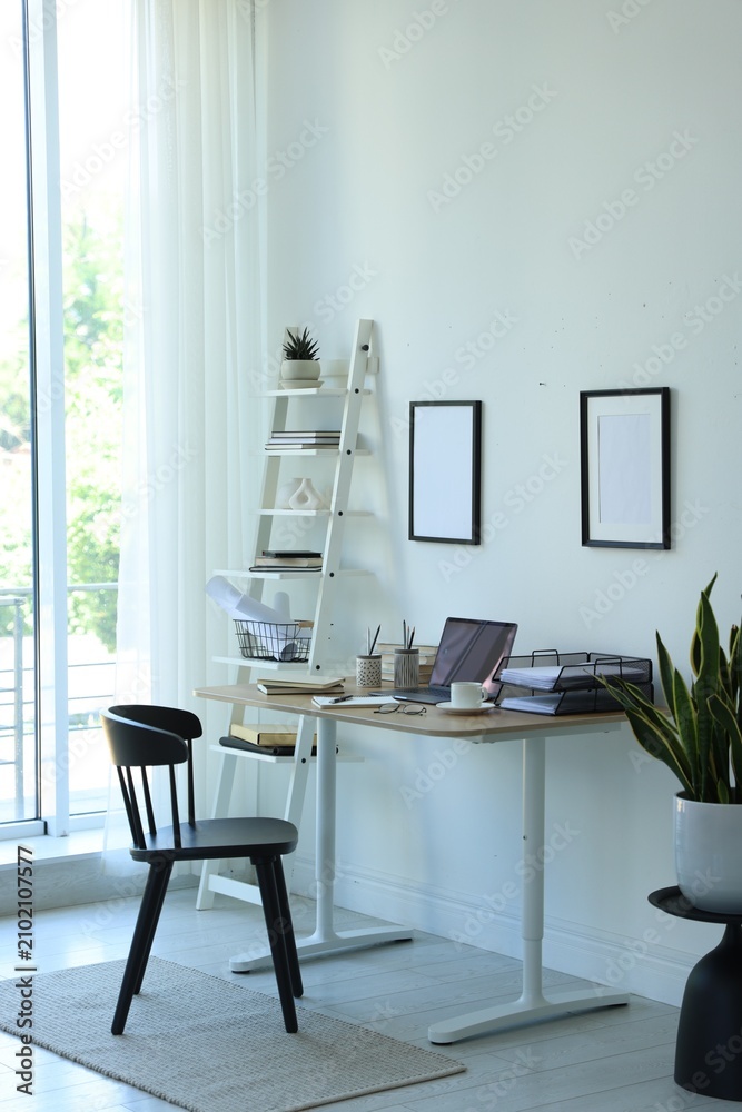 Fototapeta premium Workplace with laptop, stationery and coffee on table in office