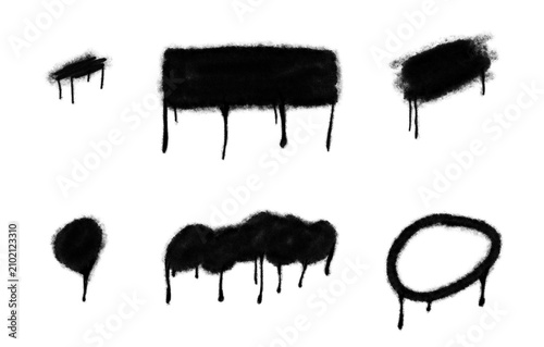 Collection of black spray paint drips and splatters on a white background