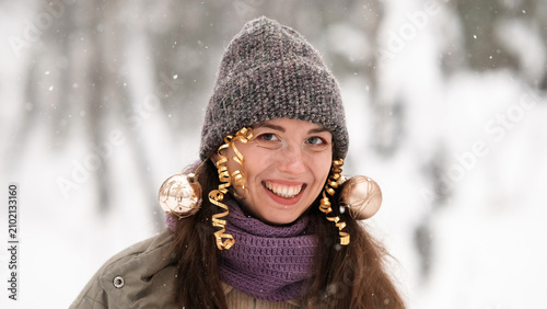Konstfotografi A beautiful young woman in winter clothes is happily spending her free time in a snowy forest