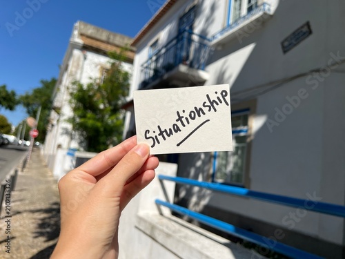 Situationship - hand with card on the street, relationship and dating psychology concept