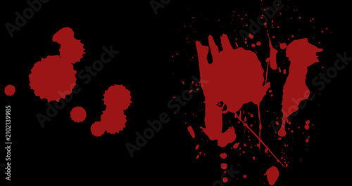 Abstract red blood splatters and ink drops isolated on a black background.