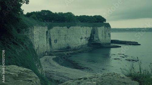 Coastal cliffs meet the tranquil sea.