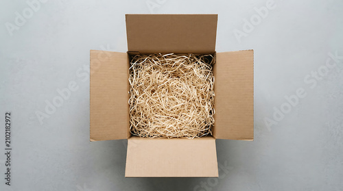 Open cardboard shipping box with wood wool filler for sustainable delivery and e-commerce concepts