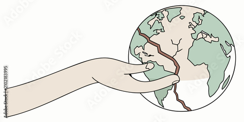 Fotografija Hand holding cracked globe symbolizing environmental fragility and global issues