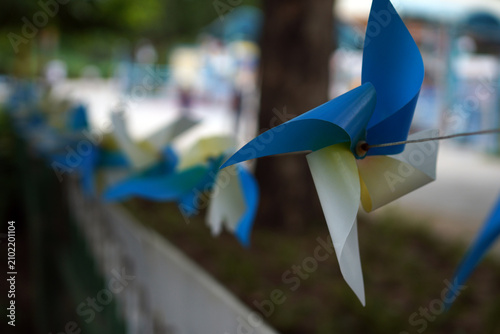 Canvas Print Blue and white pinwheel ornaments strung in outdoor setting