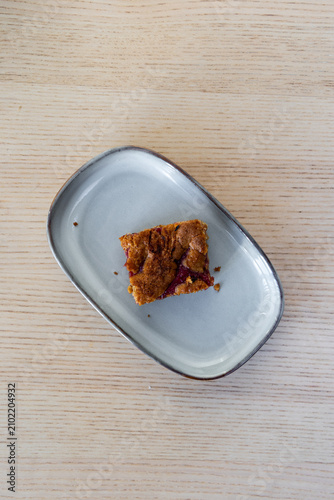 A slice of rhubarb cake bars on a plate.