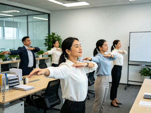 Office staff doing gentle stretches together at work